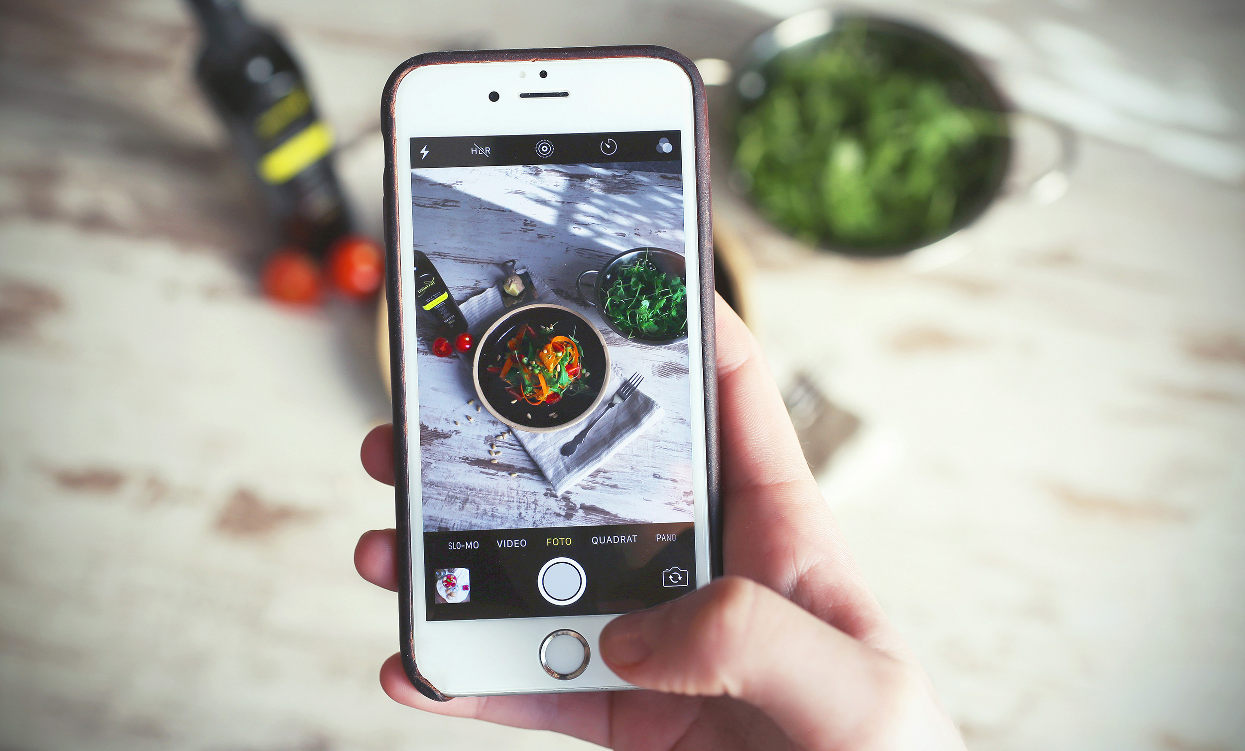 Instagram for small business hand viewing Instagram on iPhone